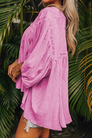 Pink embroidered yoke gathered sleeve blouse with textured fabric and voluminous sleeves.