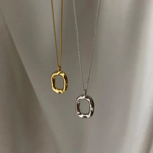 Geometric pendant necklaces in gold and silver with textured organic shapes.