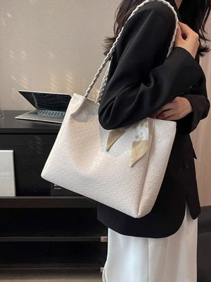 Elegant ivory tote bag with braided handles and a charming scarf detail.