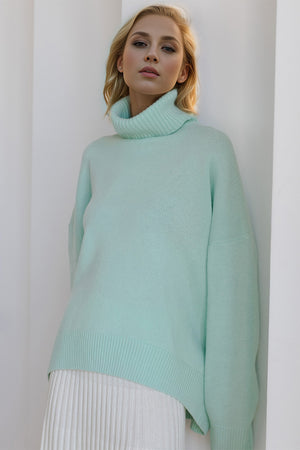 Oversized pastel blue cashmere turtleneck sweater with ribbed cuffs and hem.