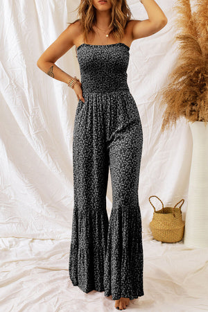 Black floral print strapless jumpsuit with smocked bodice and tiered flared legs.