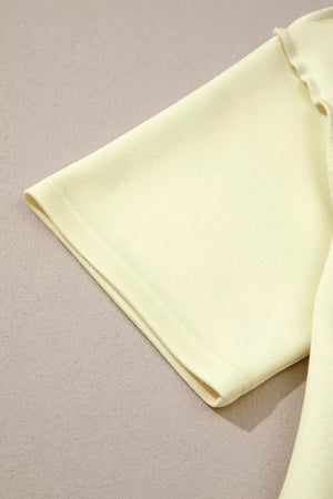 Light yellow mock neck two-piece set with dropped shoulders and lettuce trim detail.