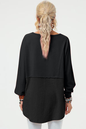 Black split-panel sweatshirt with textured lower panel and asymmetric hemline.