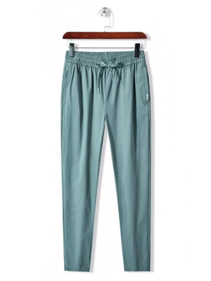 Men's turquoise drawstring active pants with elastic waistband and pockets.