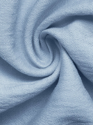 Blue maternity wrap romper fabric detail with soft texture and draped folds.