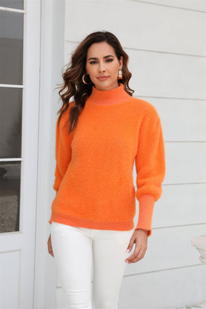 Fluffy mock neck sweater in tangerine with puff sleeves and ribbed cuffs.