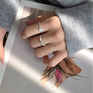 Twisted band sterling silver ring with zircon flower detail and a second plain band ring.