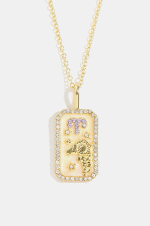 Gold-plated necklace with rectangular Aries zodiac sign pendant, crystal accents and purple details.