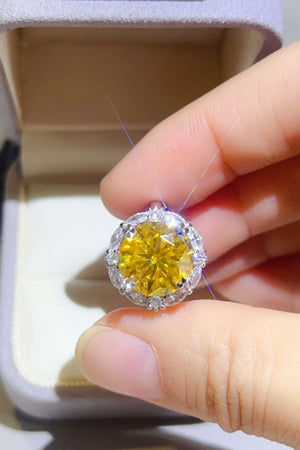 Radiant Halo Yellow Gemstone Ring with clear accent stones.