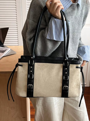 Two-tone suede tote bag with black leather trim and buckle details.