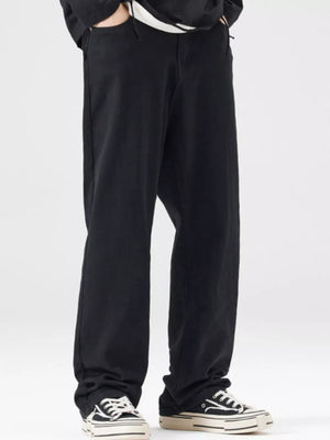 Black wide-leg jeans for men with a relaxed fit, styled casually.