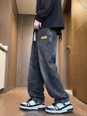 Dark gray vintage wash straight-leg jeans with a leather logo patch and contrast stitching.