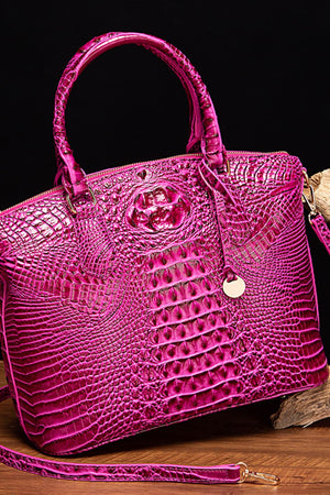 Fuchsia pink crocodile embossed satchel bag with top handle and gold hardware detail.