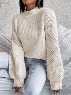 Cream textured puff sleeve mock neck knit sweater with waffle knit detail.