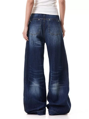 Belted wide leg jeans in washed denim with a relaxed fit.