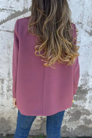 Dusty pink double-breasted blazer with sculpted lapels, shown from the back.