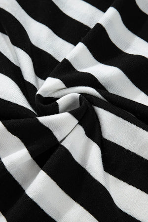 Graphic ribbed turtleneck sweater in black and white stripes.