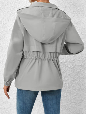 Gray hooded utility jacket with cinched waist detail and elastic cuffs.