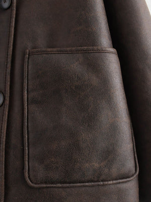 Chocolate aviator jacket with a patch pocket and button detail.