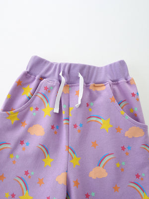 Lavender cotton toddler shorts with rainbow and star print, elastic waistband and drawstring.