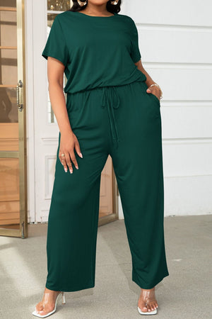 Relaxed fit jumpsuit in Forest green with drawstring waist and wide legs.