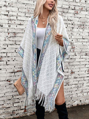 White knit hooded wrap with embroidered trim and fringe detail, acrylic.