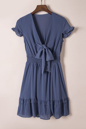 Dusty blue ruffled bow-tie V-neck mini dress with smocked waist and tiered ruffled hem.