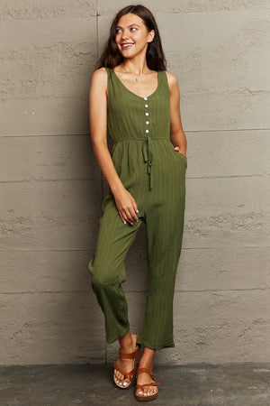 Matcha green linen blend button-down jumpsuit with drawstring waist and wide legs.