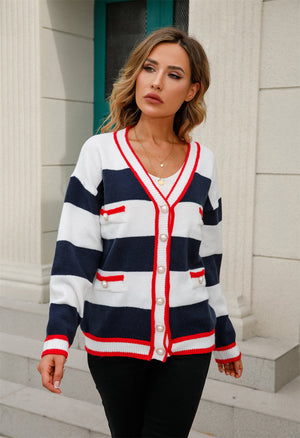 Striped knit cardigan with pearl buttons and red trim, navy and white.
