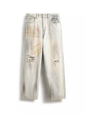 Distressed light wash wide-leg jeans with unique patchwork details and ripped accents.