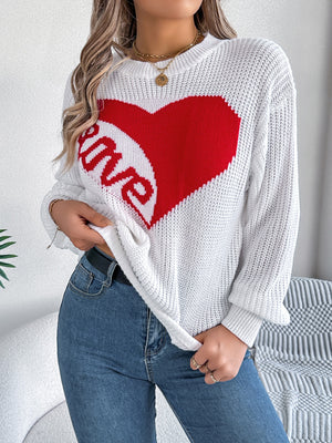 White knit sweater with a large red heart graphic and the word "love" inside, crew neck, long sleeves.