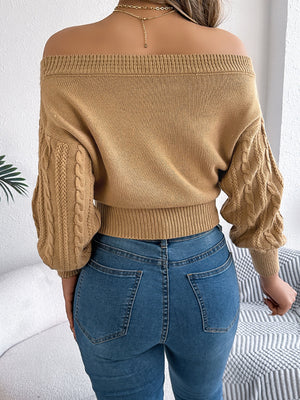 Camel cable knit off-shoulder crop sweater with textured sleeves.