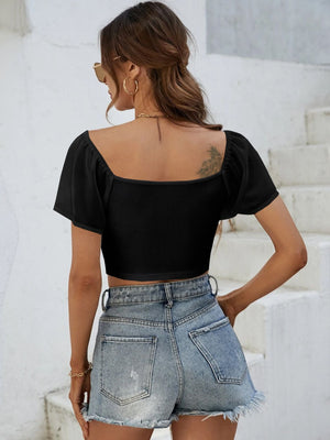 Black ribbed crop top with chiffon puff sleeves and square neckline.