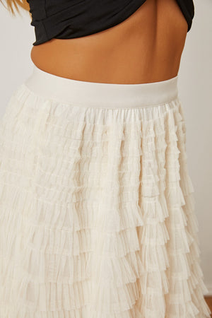 Tiered tulle maxi skirt in ivory with ruffled layers and a comfortable elastic waistband.
