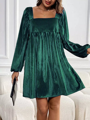 Dark green velvet mini dress with square neckline, long sleeves, and pleated texture.