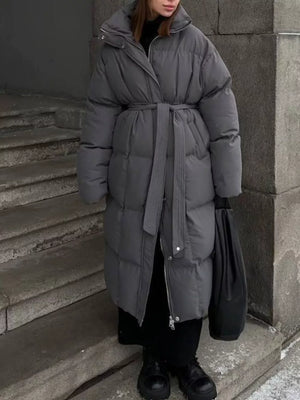 Dark gray padded trench coat with tie-belt, long sleeves, and a stand-up collar.