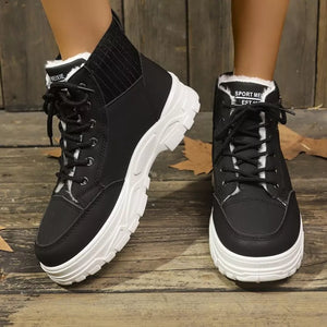 Black lace-up boots with plush white accents and a chunky white sole.