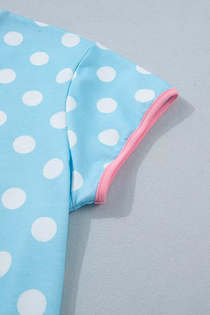 Pastel blue polka dot pajama top with pink trim on sleeve.