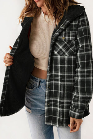 Sherpa-lined plaid overshirt jacket in black and white with button front and chest pockets.