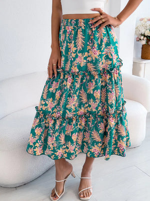 Green floral midi skirt with tiered ruffles and a ruffled hem.