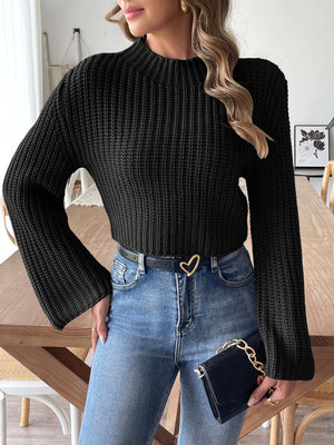 Black ribbed crop sweater with mock neck and bell sleeves.
