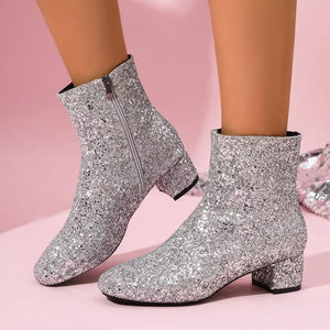 Silver sequin ankle boots with a block heel and side zipper.
