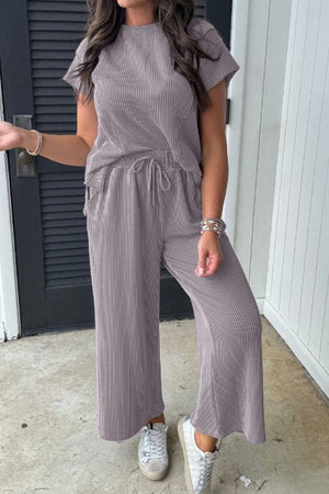 Gray ribbed knit drawstring co-ord set with short sleeves and wide-leg pants.