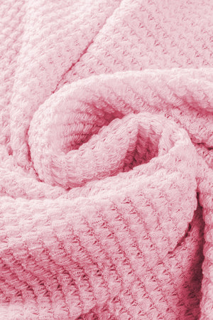 Blush pink waffle knit button-down shirt jacket detail showing texture.