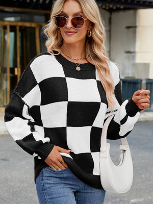 Checkerboard knit sweater in black and white with balloon sleeves and crew neck.