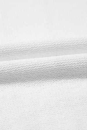 White eyelet knit blouse with puff sleeves and textured fabric detail