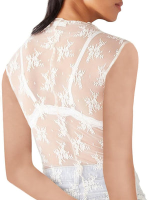 White sheer mock neck lace tank top with floral pattern and bra straps visible.