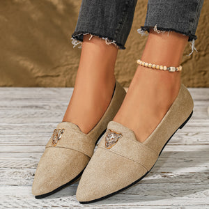 Apricot point toe slip-on flats with animal print detail and a low heel.