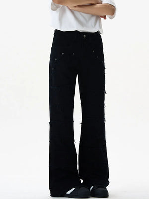 Black stretch flare jeans with frayed hem detail and distressed accents.