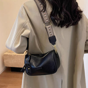 Textured black pu leather crossbody bag with patterned strap